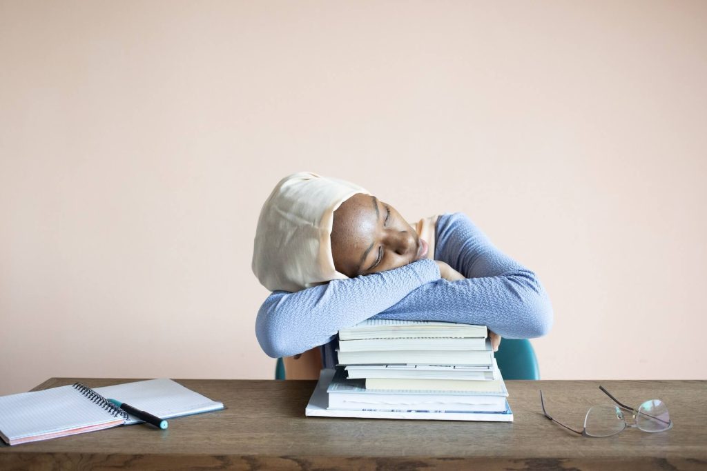 tired student sleeping on books