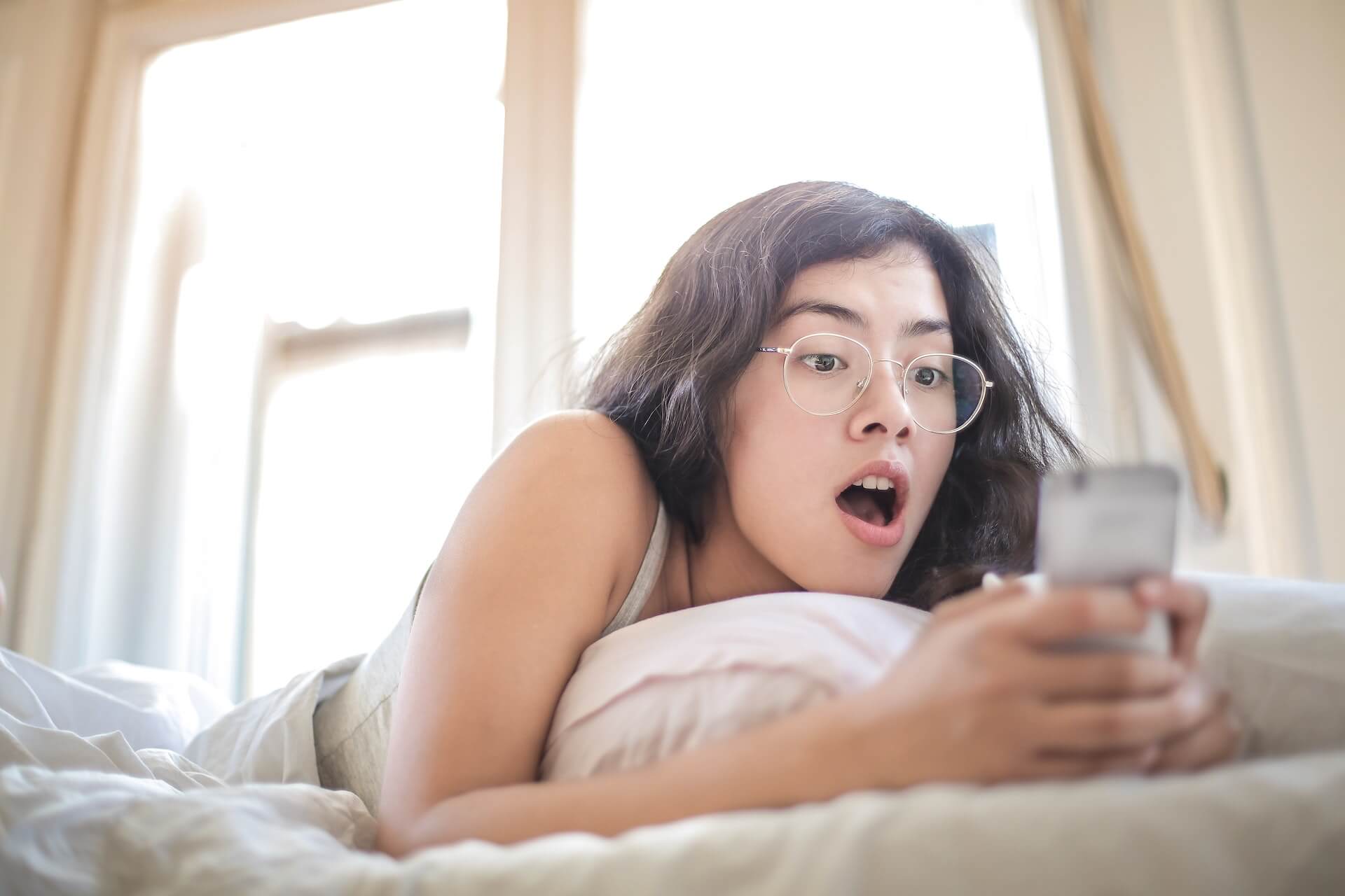 Surprised girl chatting on her phone