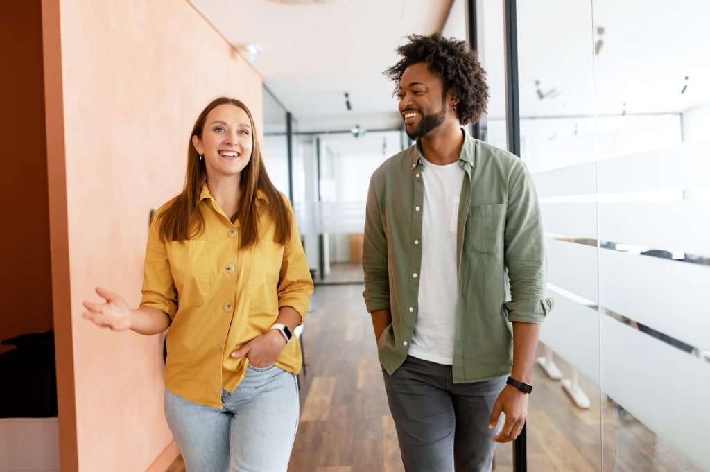 two people speaking english fluently walking down a hall
