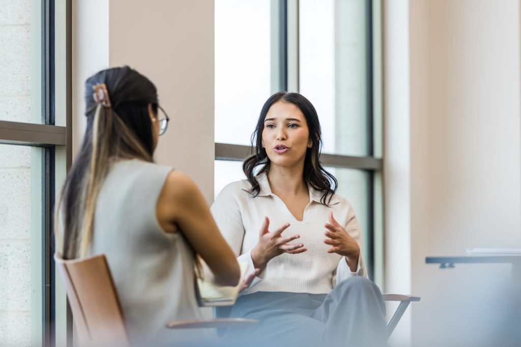 two women speaking english fluently in an office